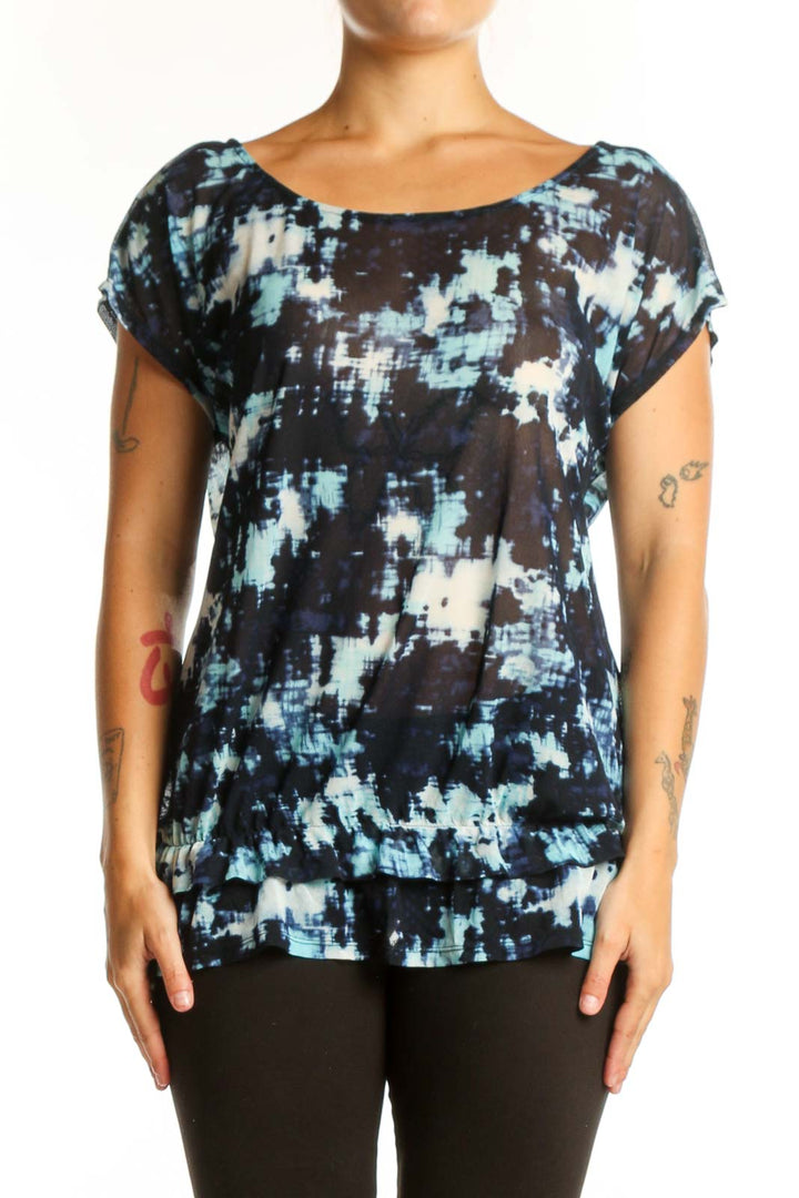 Navy abstract print short sleeve top with white and blue tie-dye pattern, front view on model