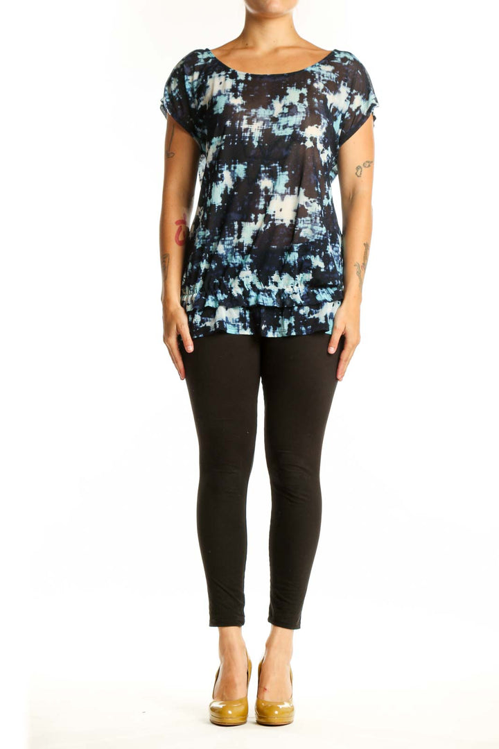 Navy abstract print short sleeve top with white and blue tie-dye pattern, front view on model