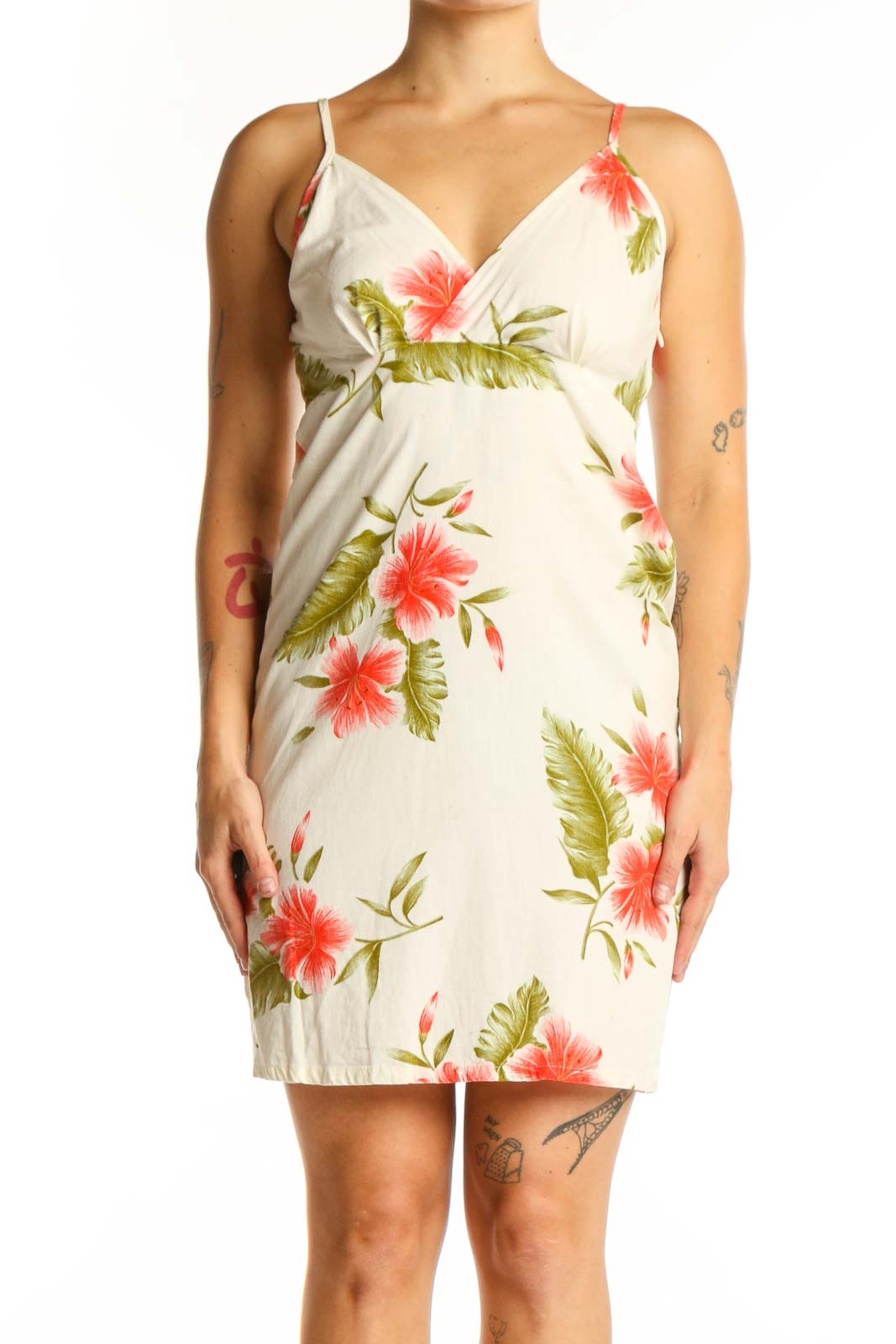 SilkRoll cream cotton wrap dress with red and green floral print, front view showing V-neckline and spaghetti straps