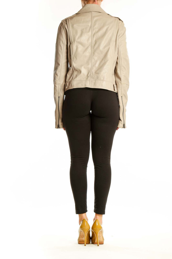 Beige leather biker jacket back view showing cropped silhouette and structured fit on model