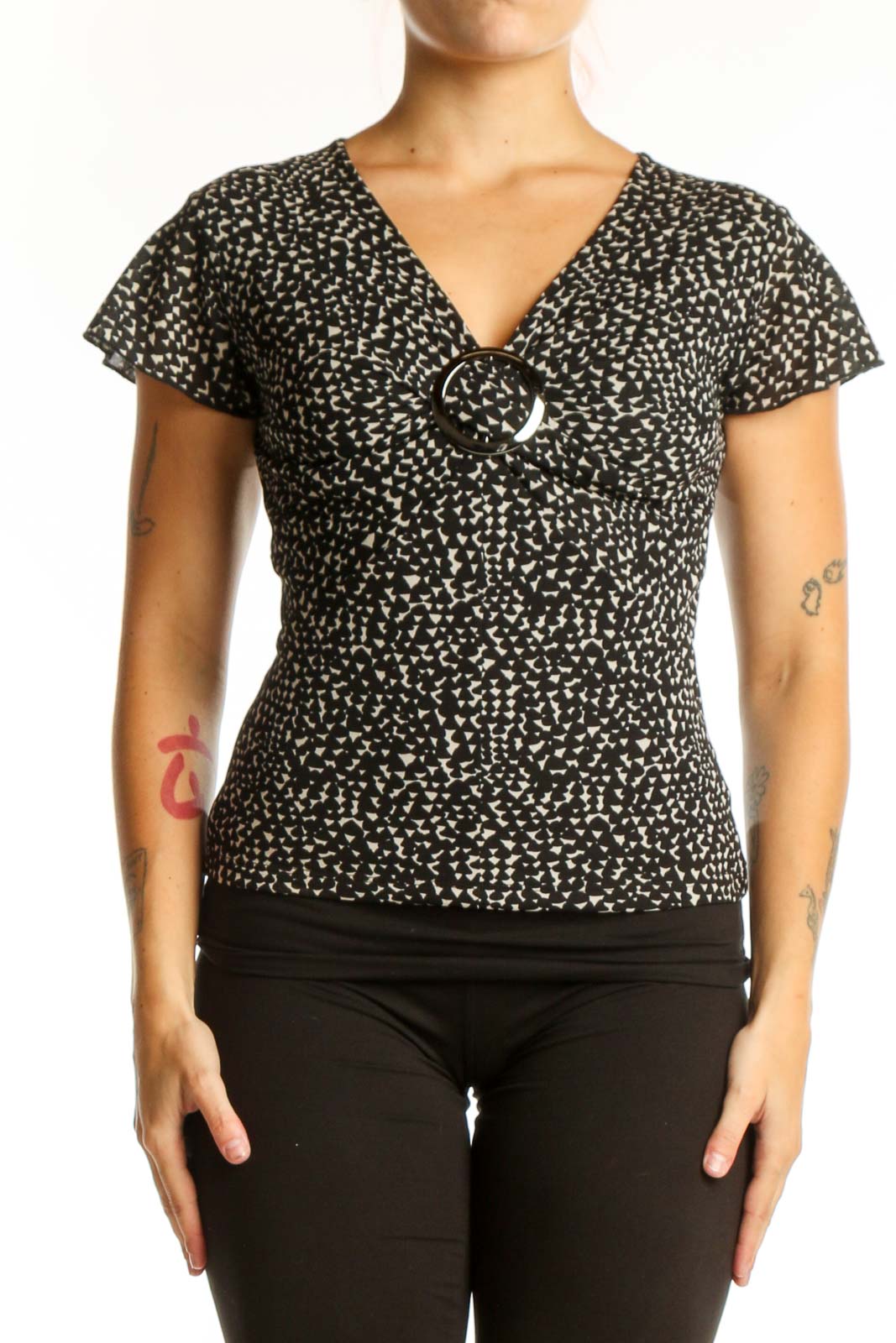 Black speckled short sleeve V-neck top with white buckle detail, front view