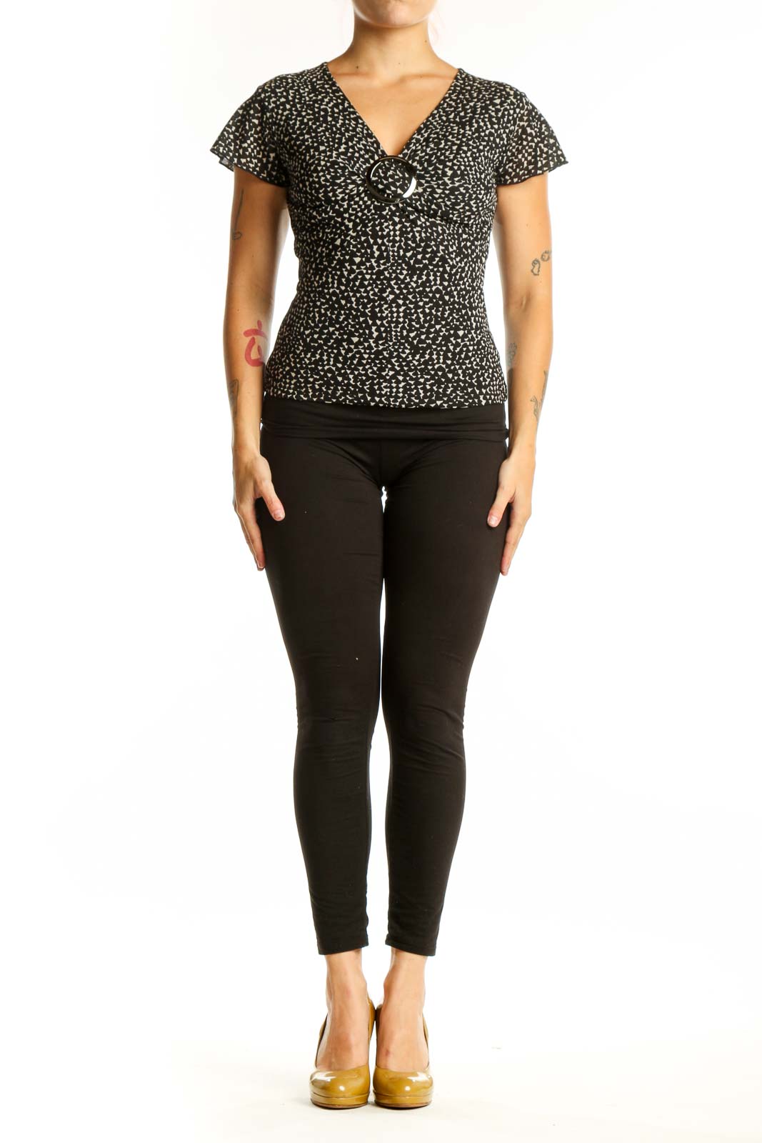 Black speckled short sleeve V-neck top with white buckle detail, front view