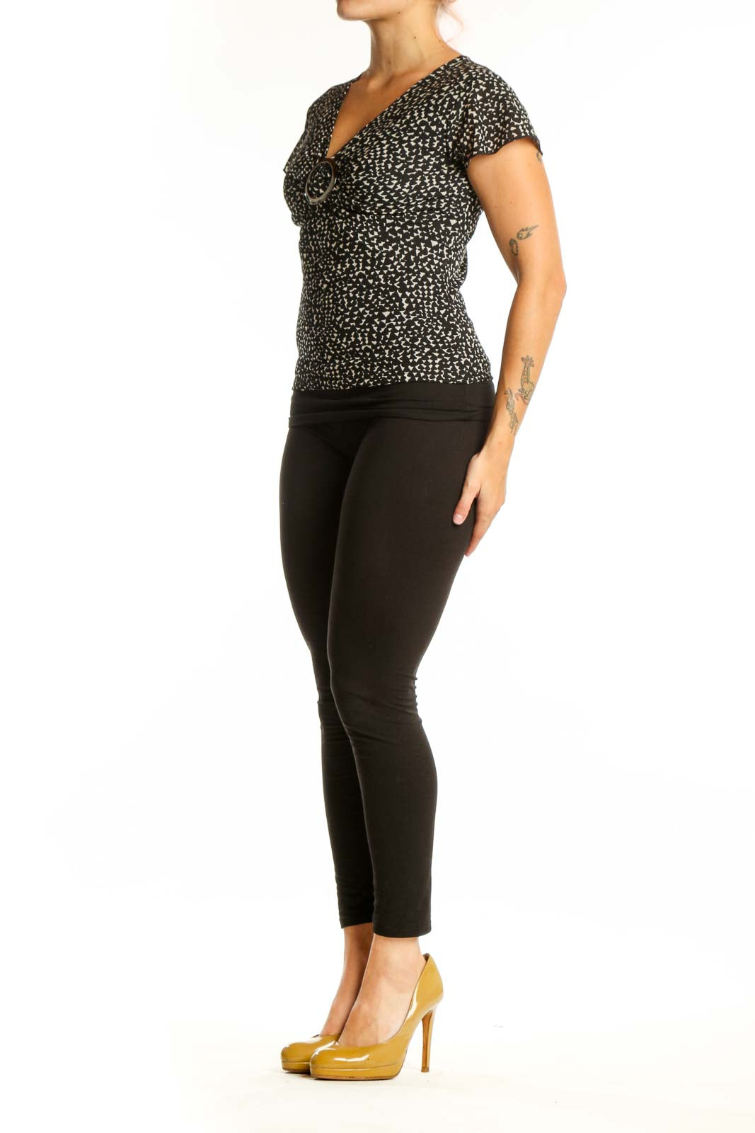 Black speckled short sleeve V-neck top with white buckle detail, front view