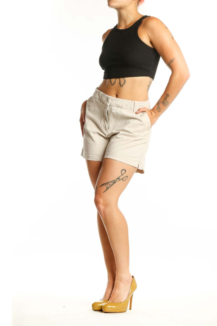 Front view of cream cotton-spandex blend shorts with zip fly closure and five-pocket design
