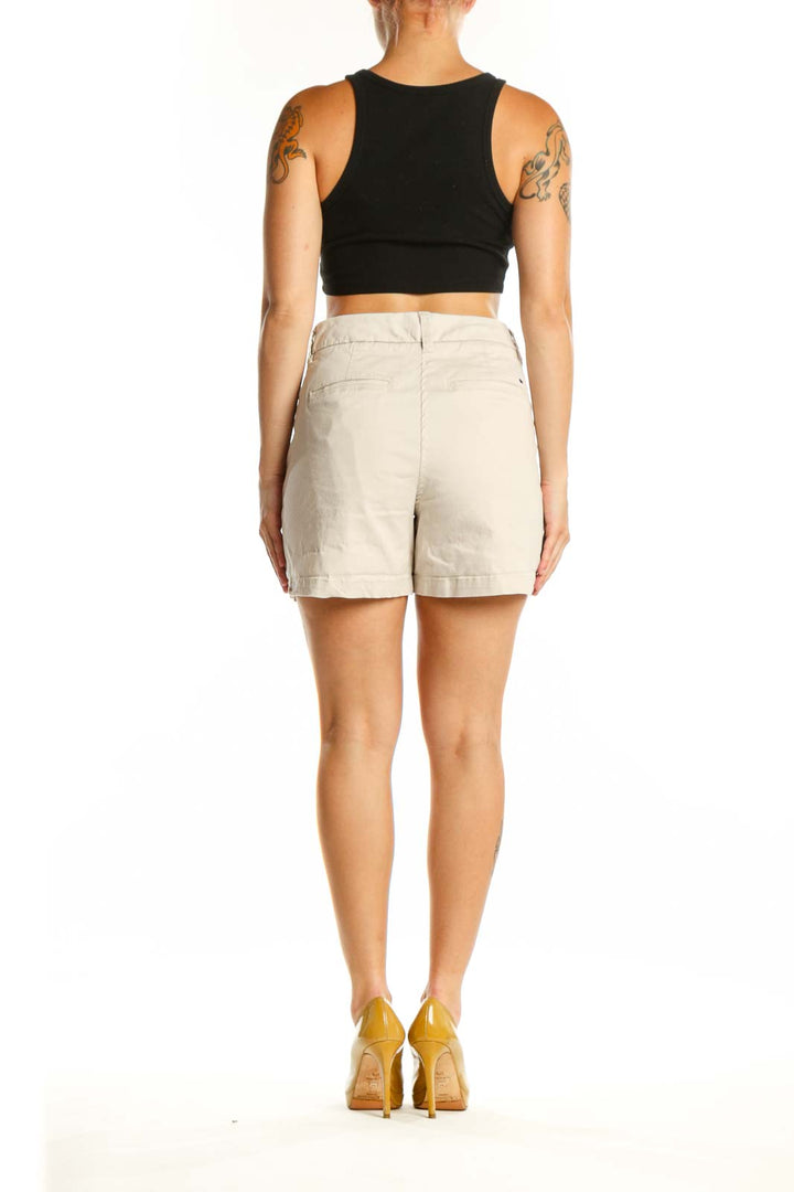Back view of cream tailored shorts showing flattering fit and classic silhouette
