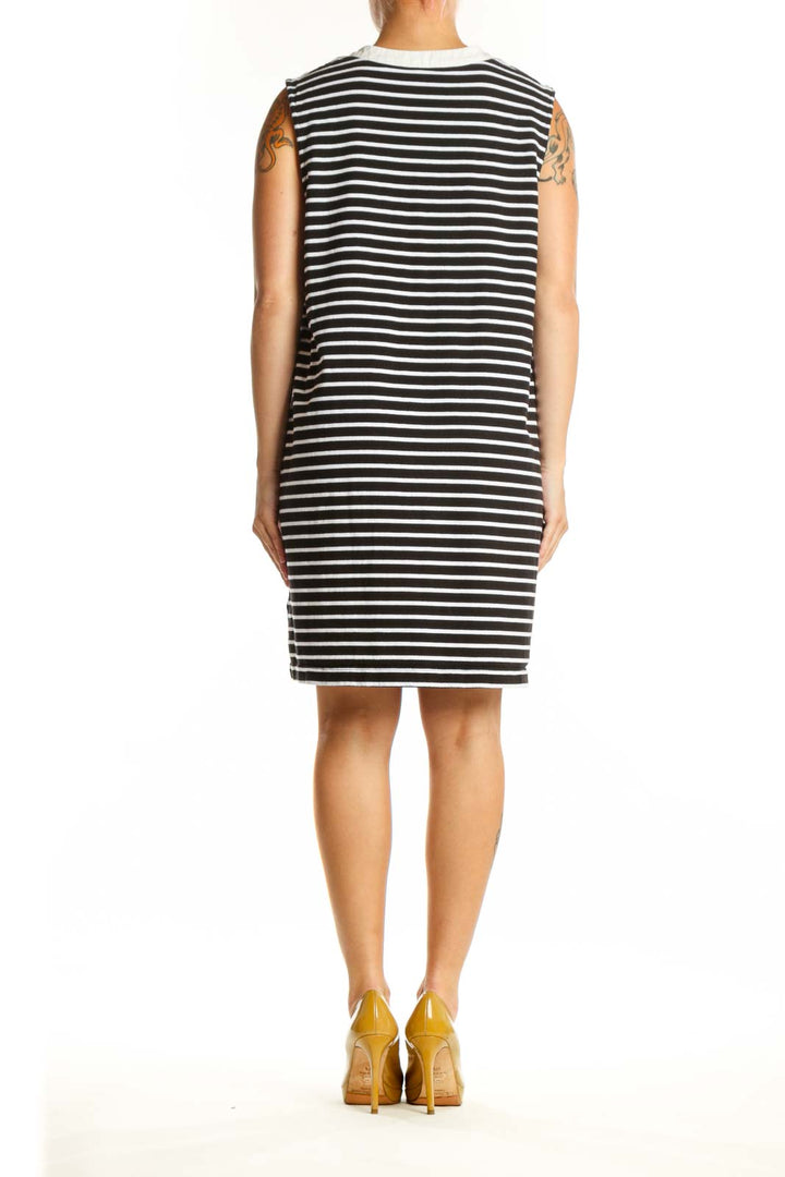 Black and white striped cotton dress back view showing relaxed A-line silhouette and sleeveless design