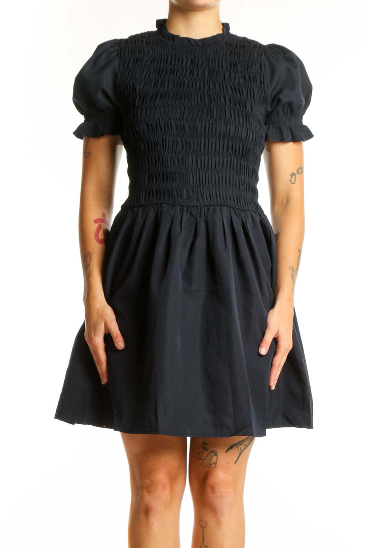 Black puff sleeve smocked fit and flare dress front view, showing fitted bodice and flowing skirt