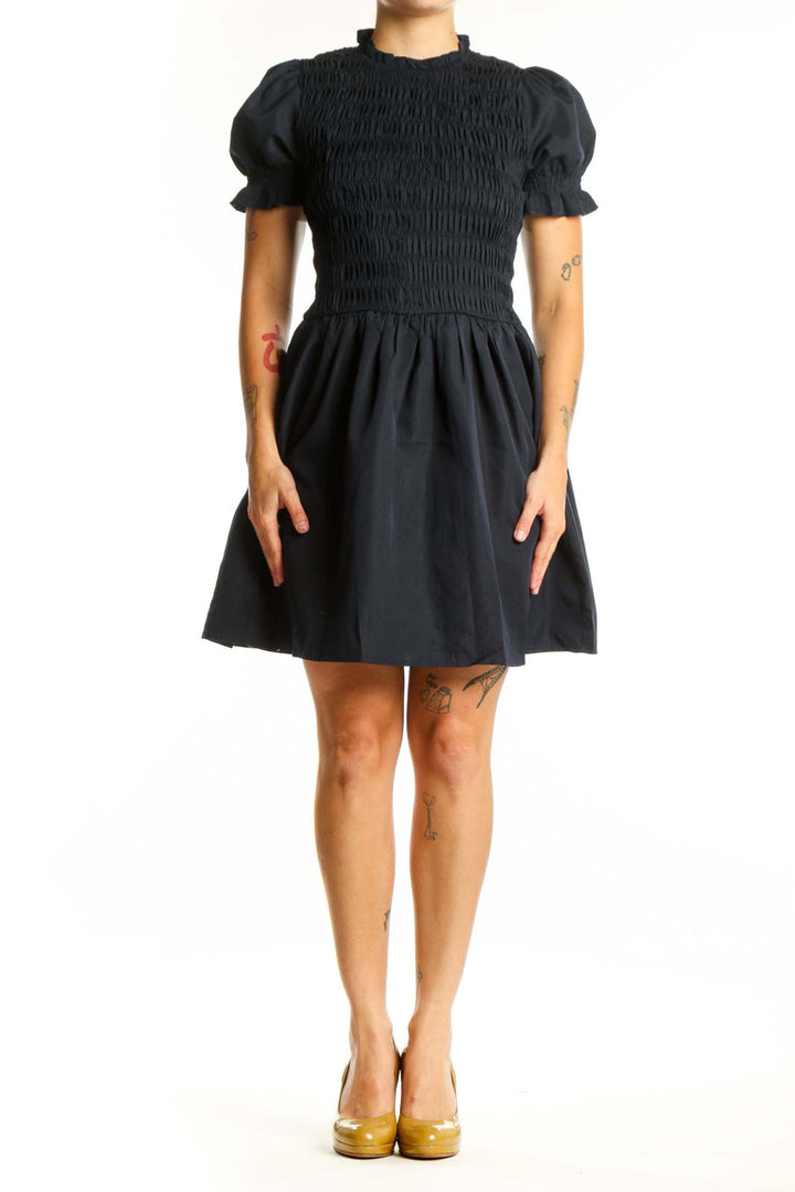 Black puff sleeve smocked fit and flare dress front view, showing fitted bodice and flowing skirt