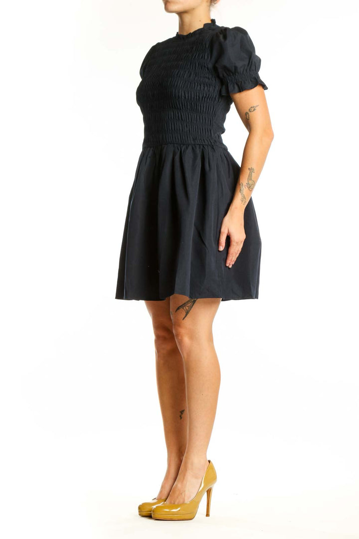Black puff sleeve smocked fit and flare dress front view, showing fitted bodice and flowing skirt