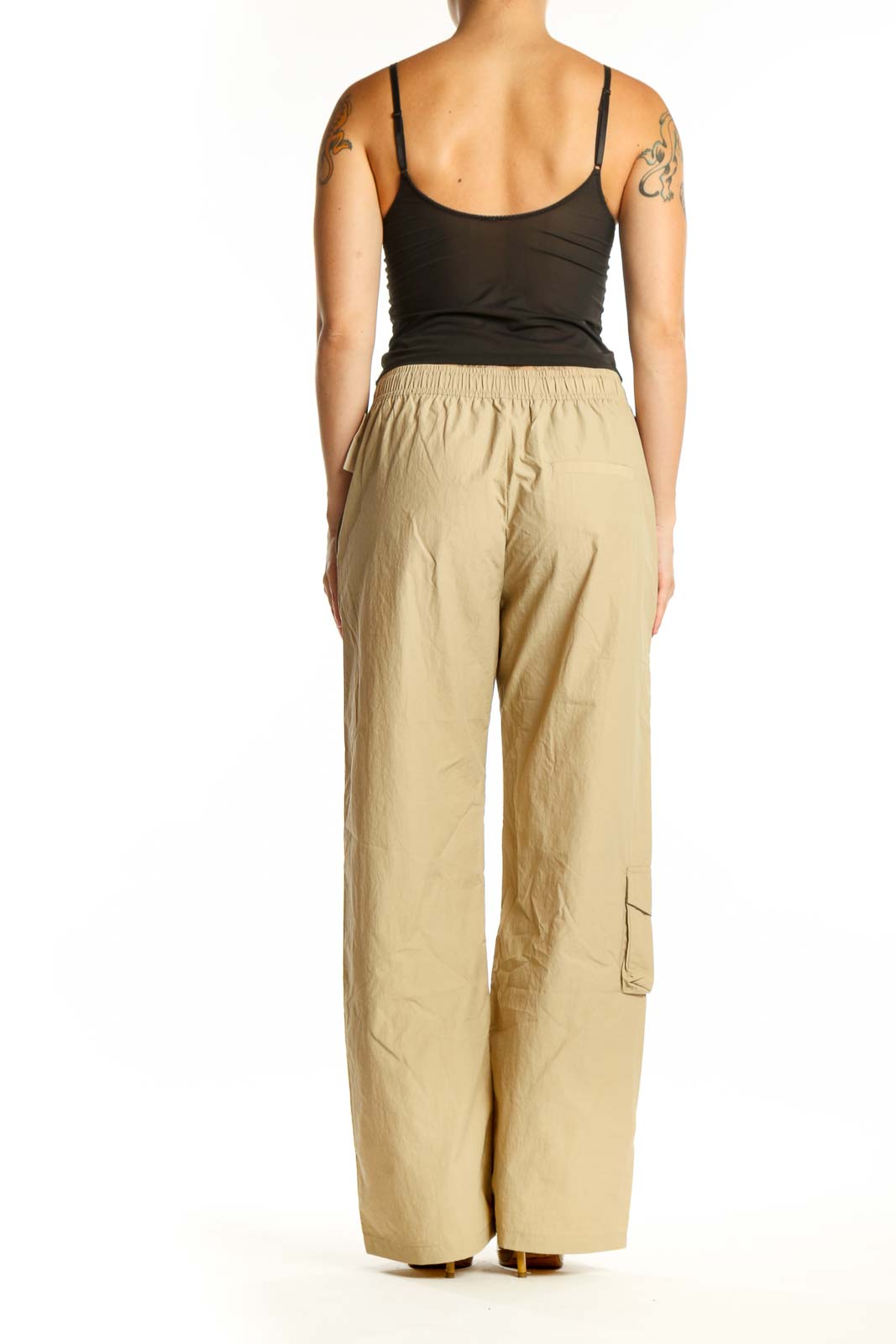 Beige cargo pants with drawstring waist and functional pockets, back view on model