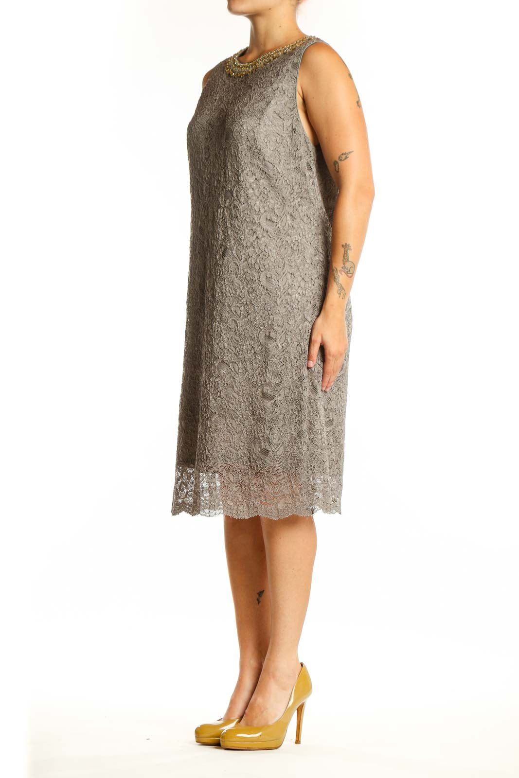 Gray lace cocktail dress with gold beaded neckline, sleeveless design, and lace hem detail