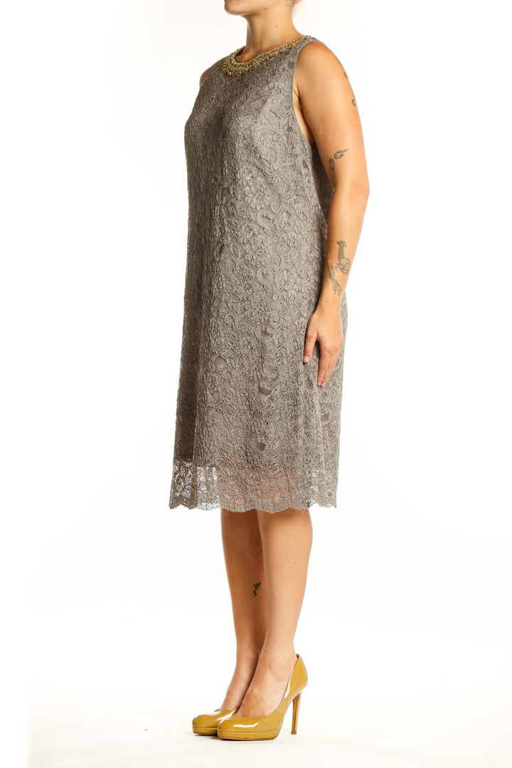 Gray lace cocktail dress with gold beaded neckline, sleeveless design, and lace hem detail