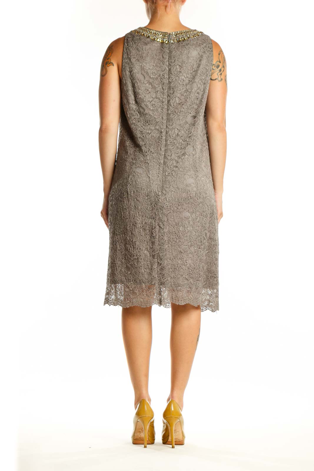 Back view of gray lace cocktail dress showing sleeveless silhouette and textured lace pattern