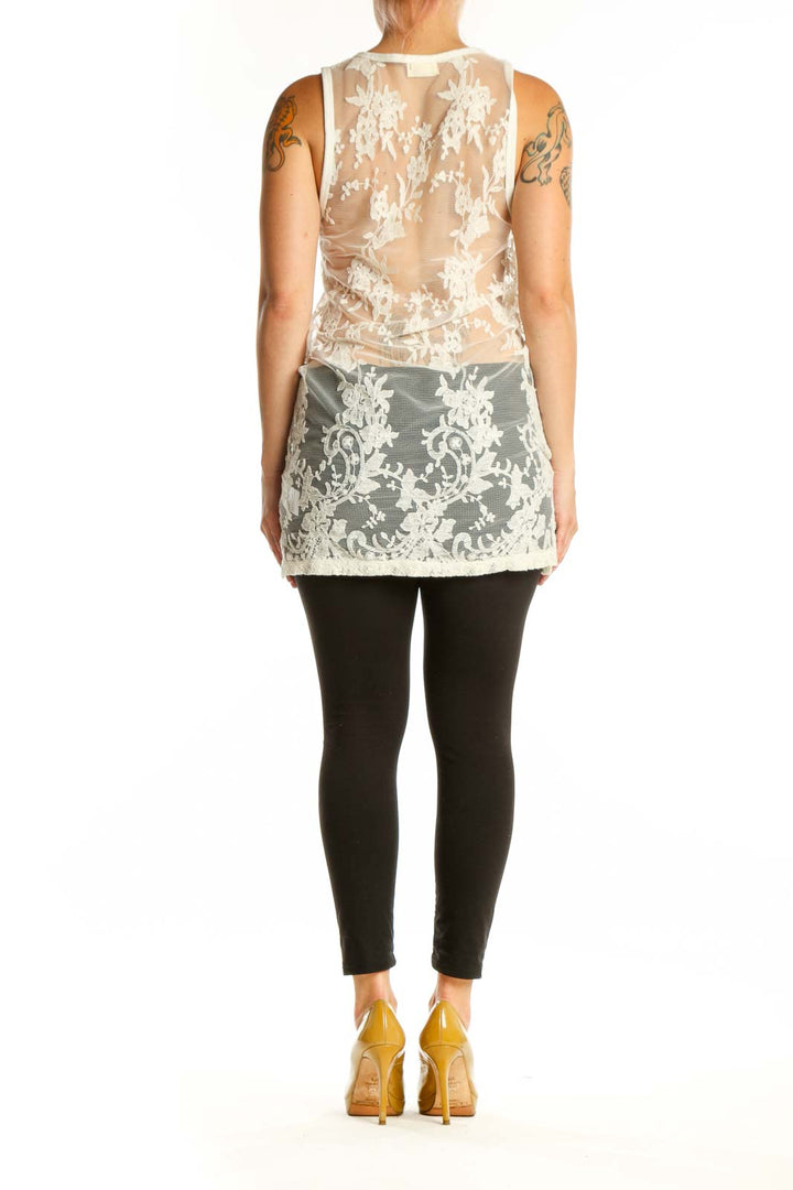 Back view of cream lace tank top showing ornamental lace pattern and sage green underlay detail
