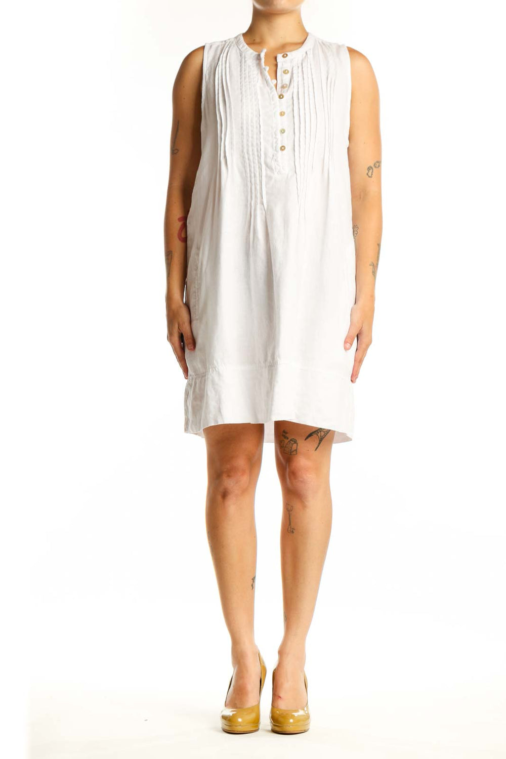 White linen sleeveless button-front dress with vertical pleating and henley neckline, front view