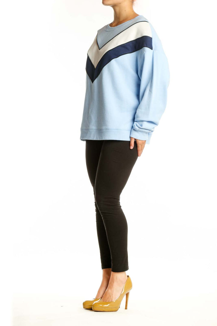 Light blue colorblock chevron sweatshirt with navy and cream geometric stripes, front view