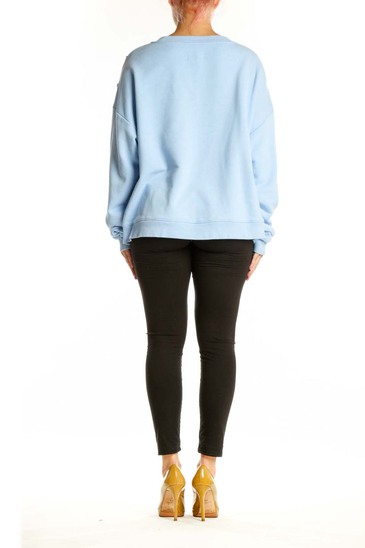 Light blue colorblock chevron sweatshirt with navy and cream geometric stripes, back view