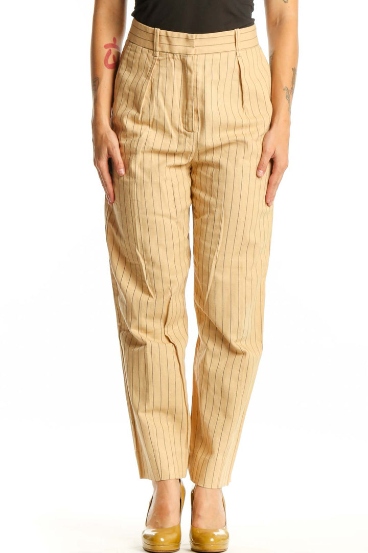 Front view of cream pinstriped Maje pleated trousers with high-waisted design and straight-leg cut