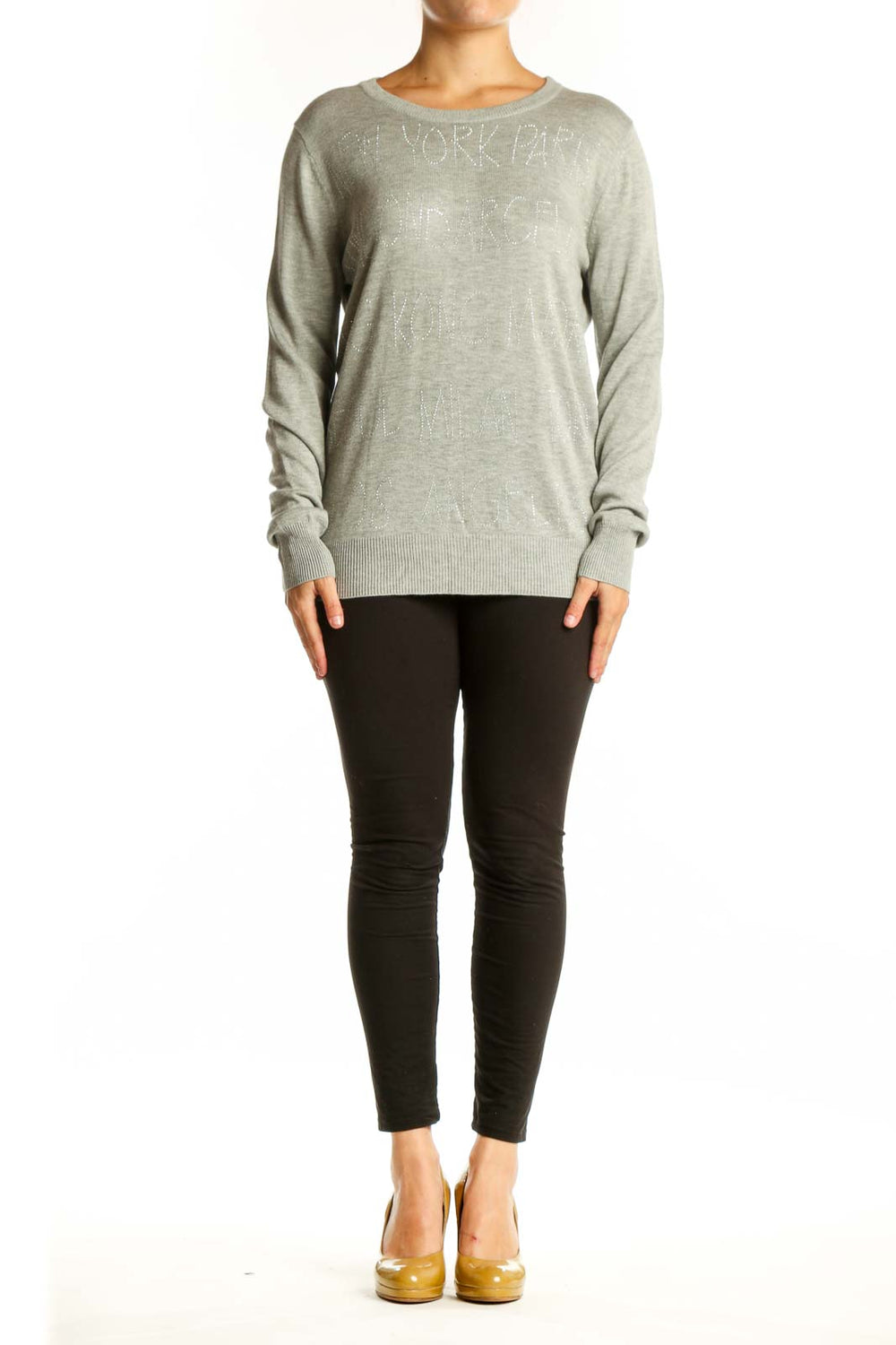 Beige cashmere blend knit pullover with embellished text detail, crew neckline, and long sleeves on model
