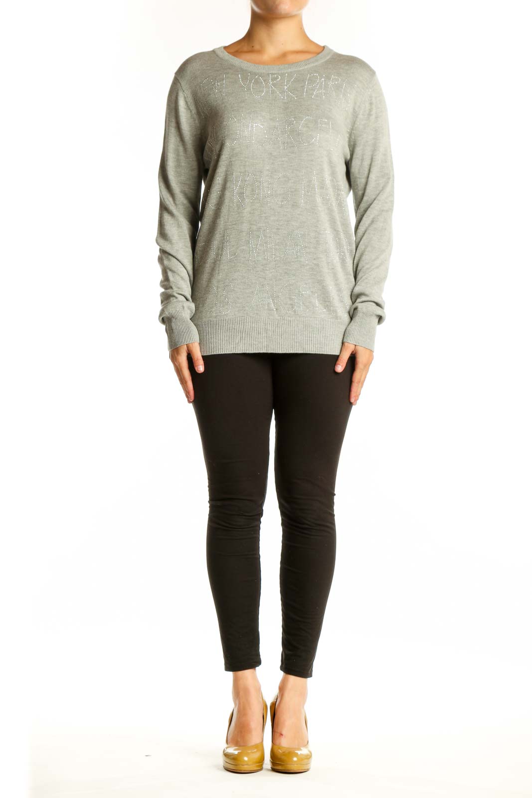 Beige cashmere blend knit pullover with embellished text detail, crew neckline, and long sleeves on model