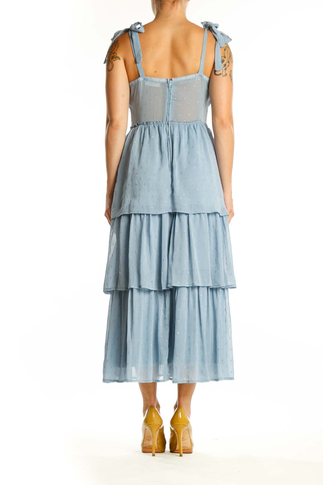 Back view of blue tiered ruched midi dress showing layered skirt design and tie shoulder straps