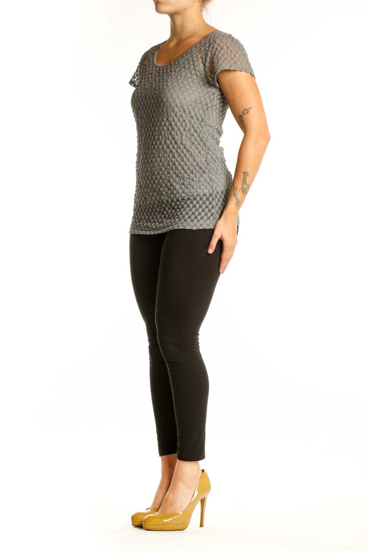Gray textured short sleeve knit top with quilted geometric pattern, front view