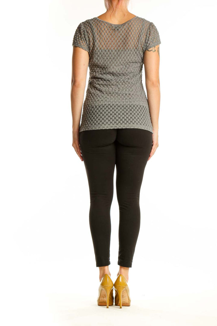 Gray textured short sleeve knit top with quilted geometric pattern, back view