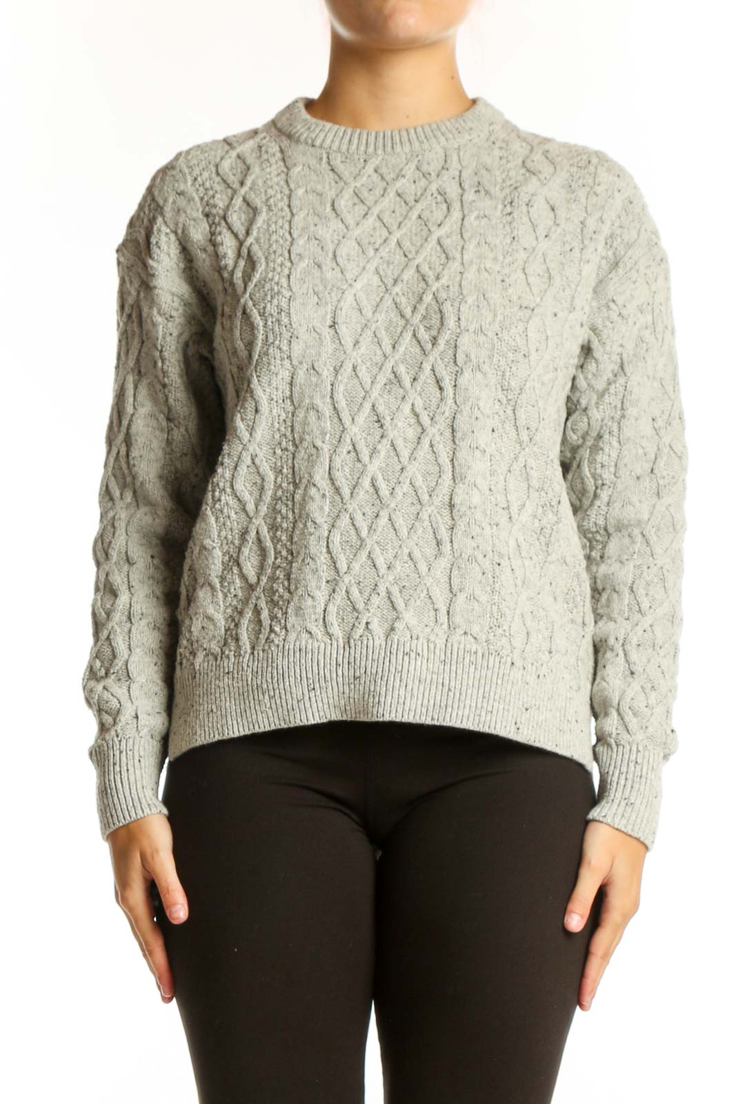 Cream cable knit pullover sweater with diamond pattern, crew neck, and long sleeves on model