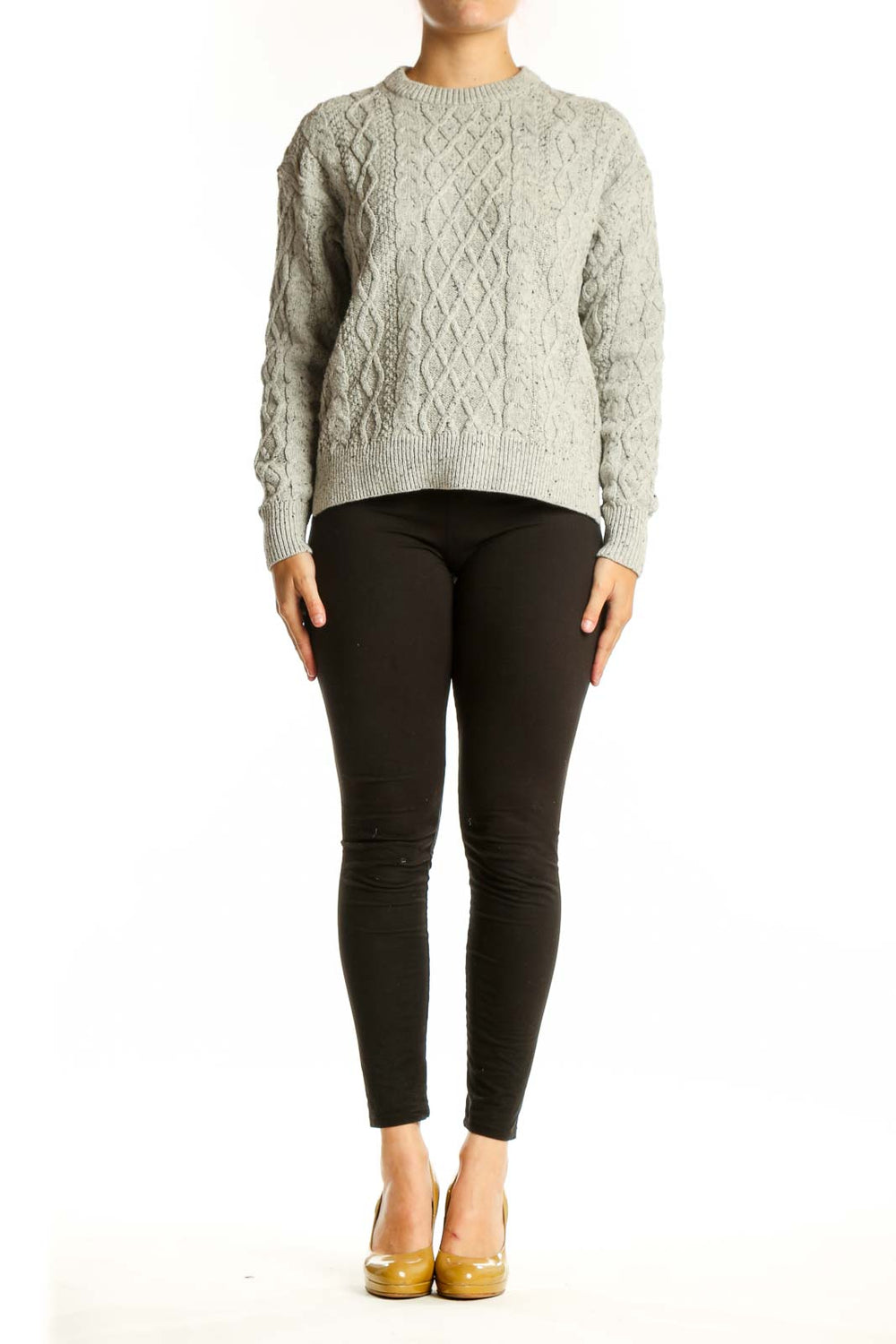 Cream cable knit pullover sweater with diamond pattern, crew neck, and long sleeves on model