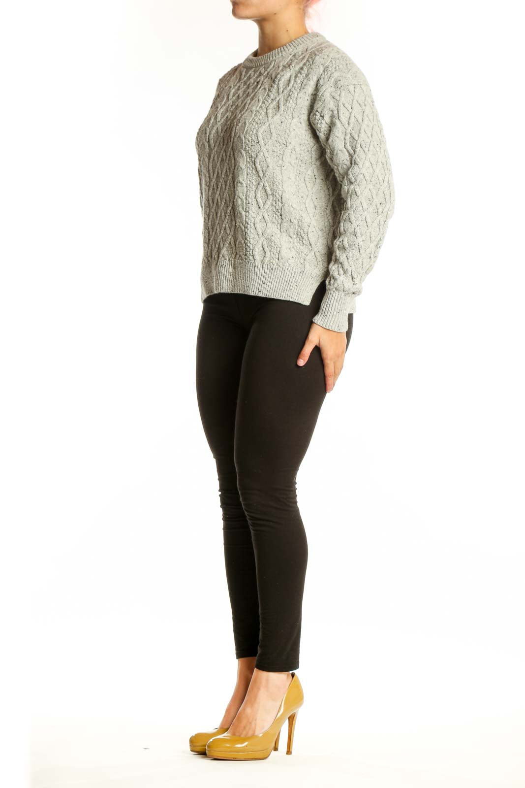 Cream cable knit pullover sweater with diamond pattern, crew neck, and long sleeves on model