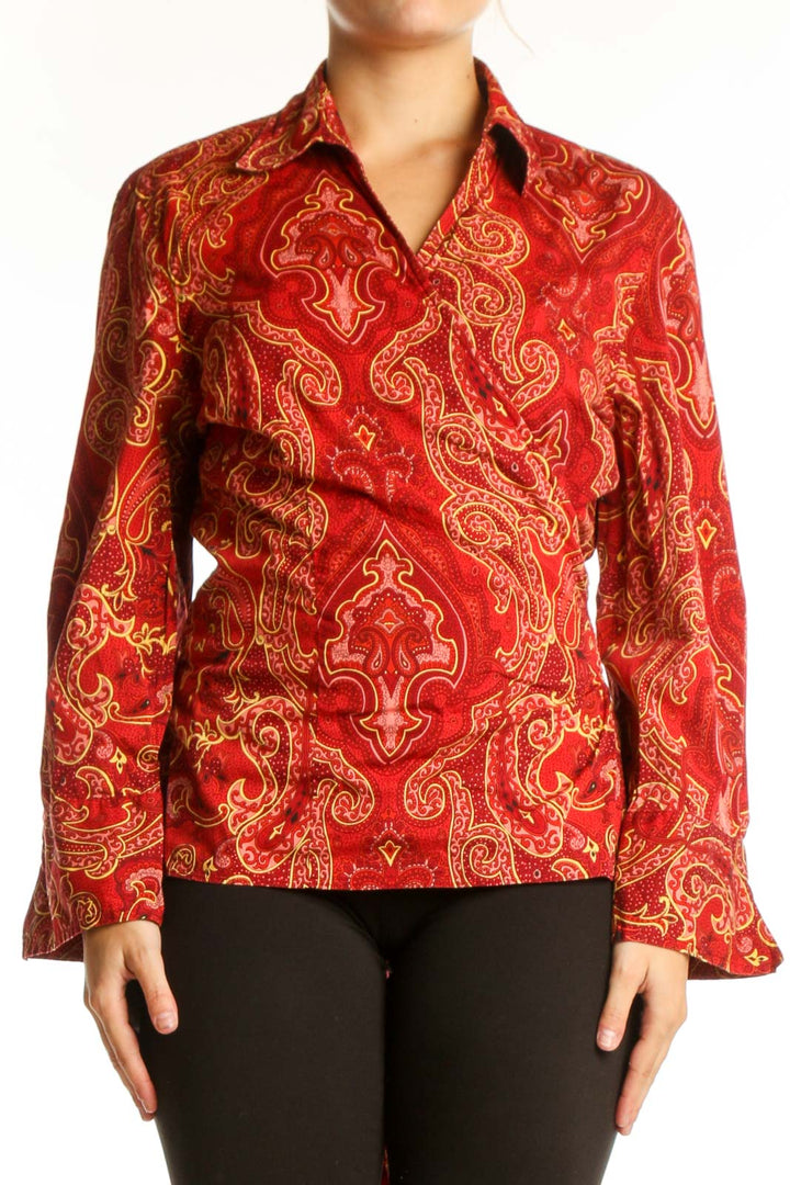 Red and gold paisley print button-up blouse with long sleeves and collar, front view