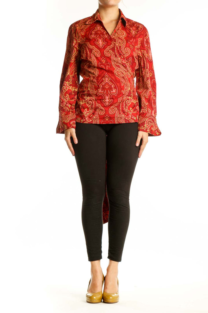 Red and gold paisley print button-up blouse with long sleeves and collar, front view