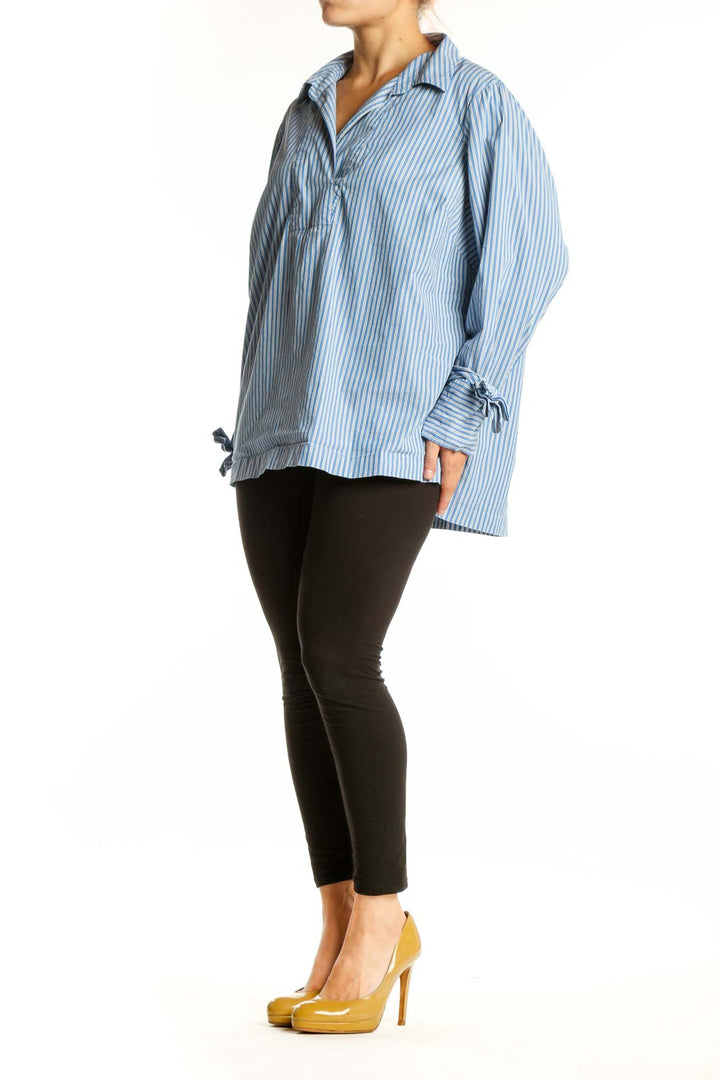 Blue and white striped pullover top with collared neckline and tie-cuff sleeves, front view