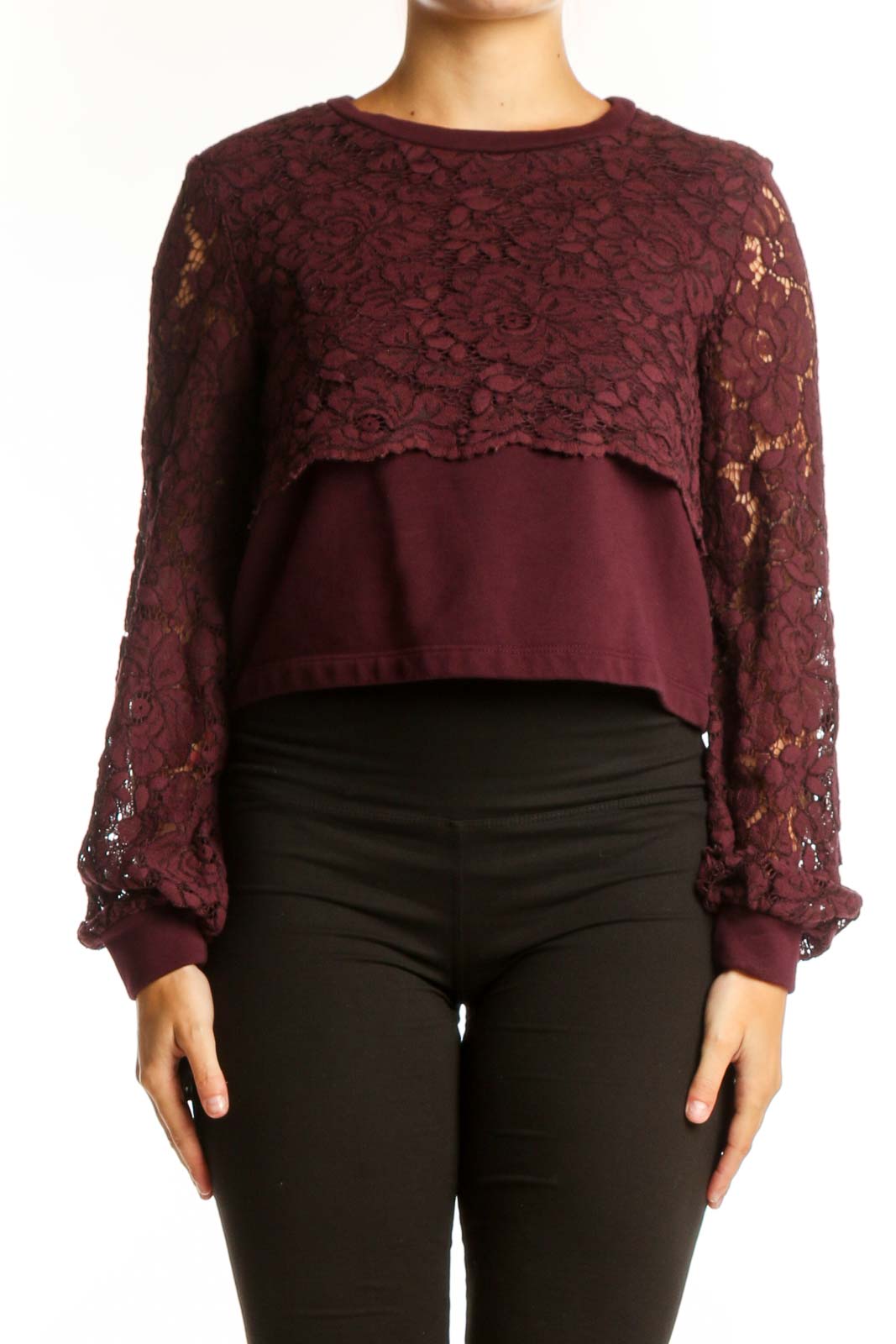 Burgundy lace cropped knit top with long voluminous sleeves and solid panel, styled with black pants