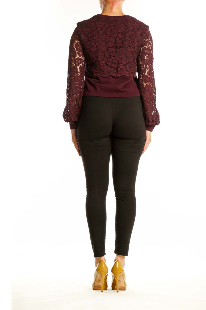 Back view of burgundy lace cropped knit top showing lace sleeve detail and cropped silhouette