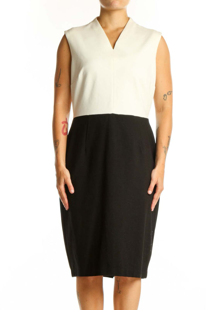 Front view of cream and black colorblock sleeveless dress with V-neckline and midi length