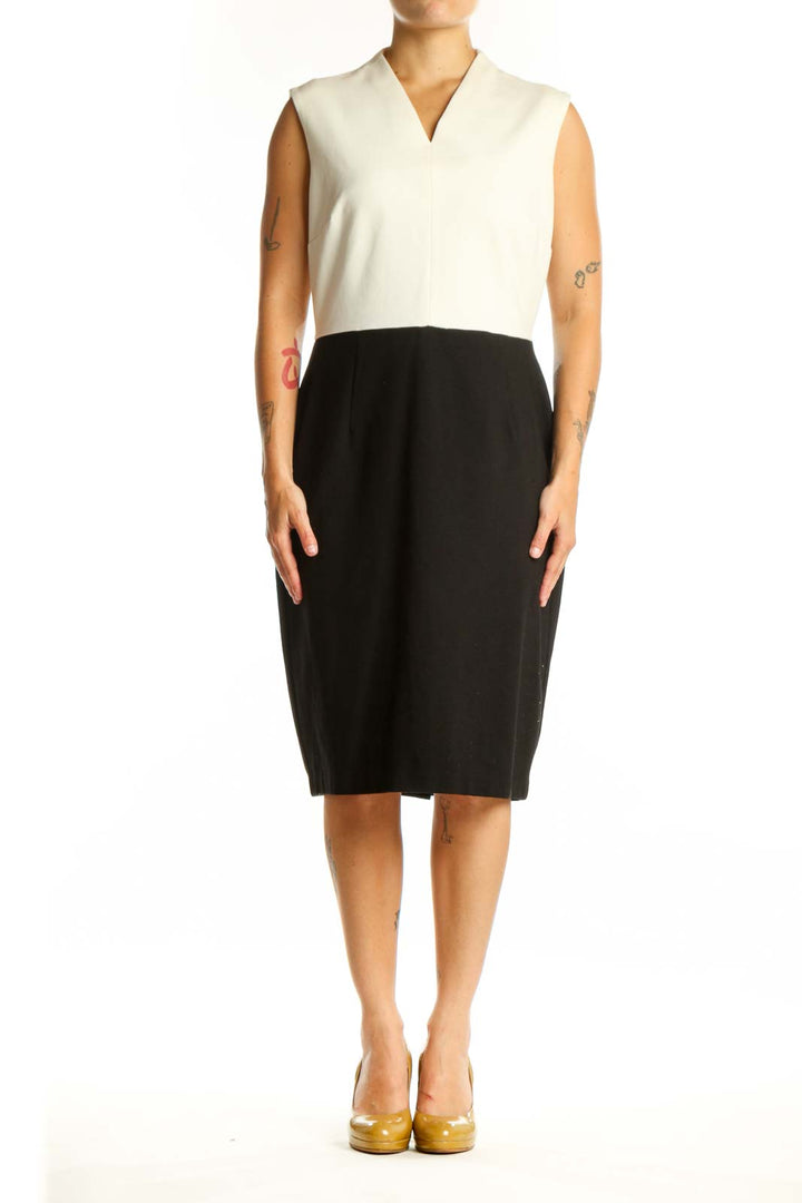 Front view of cream and black colorblock sleeveless dress with V-neckline and midi length