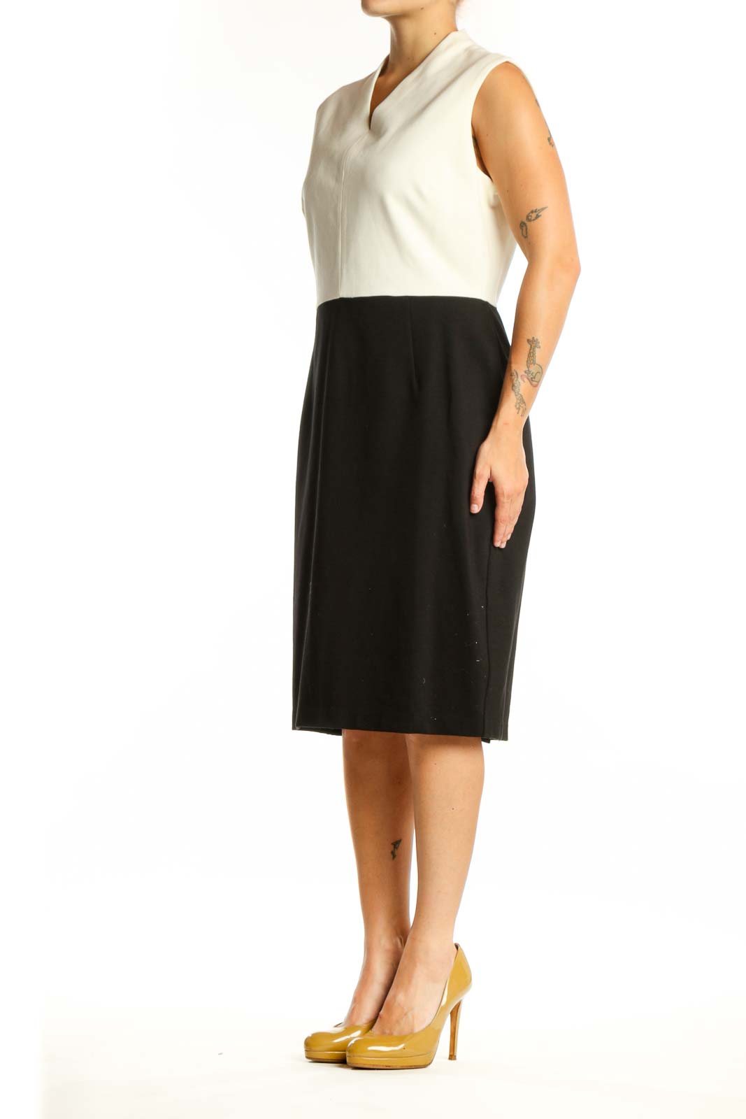 Front view of cream and black colorblock sleeveless dress with V-neckline and midi length