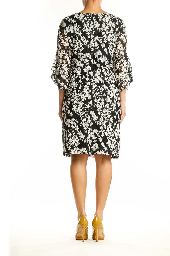 Black and white floral print dress with three-quarter sleeves, back view