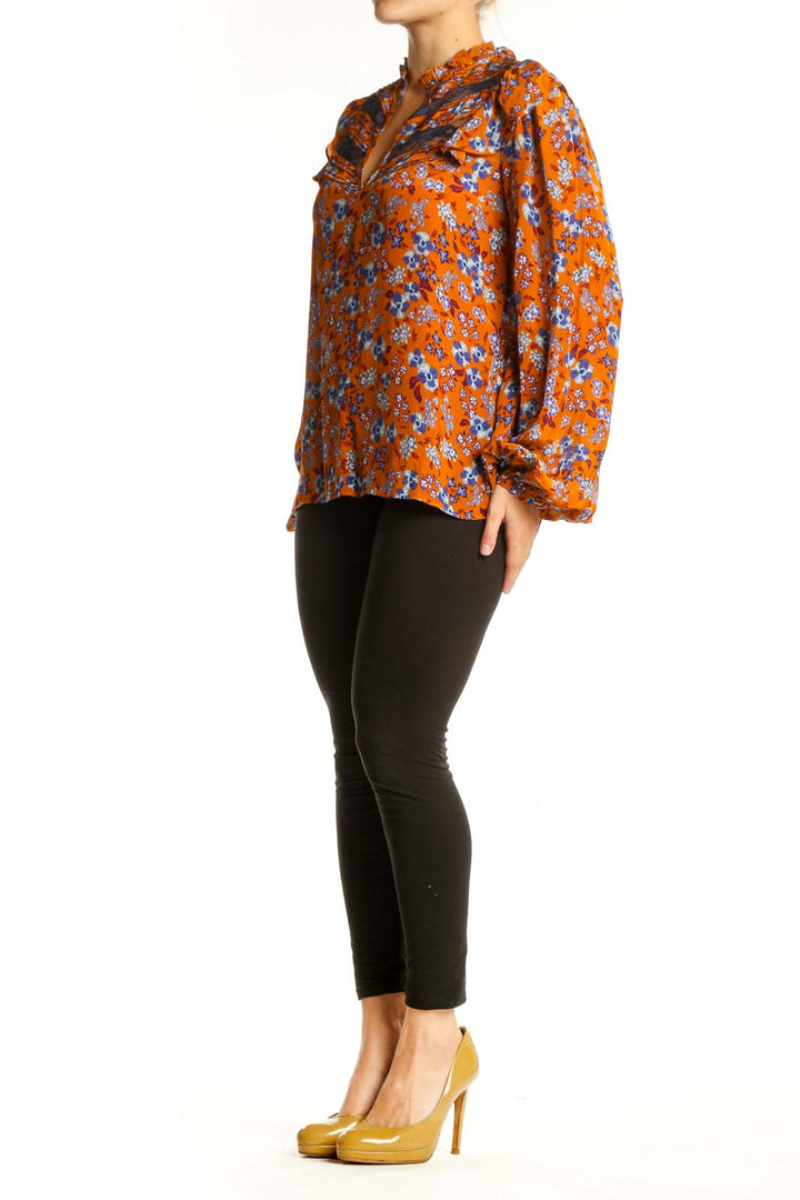 Orange floral viscose blouse with ruched shoulders, bell sleeves, and keyhole neckline by Gilner Farrar