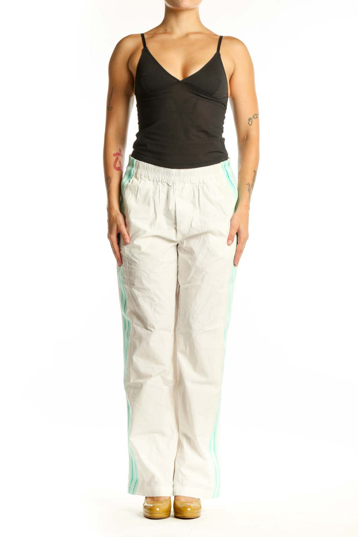 Front view of cream and mint colorblock track pants with side stripe detail and elastic waistband