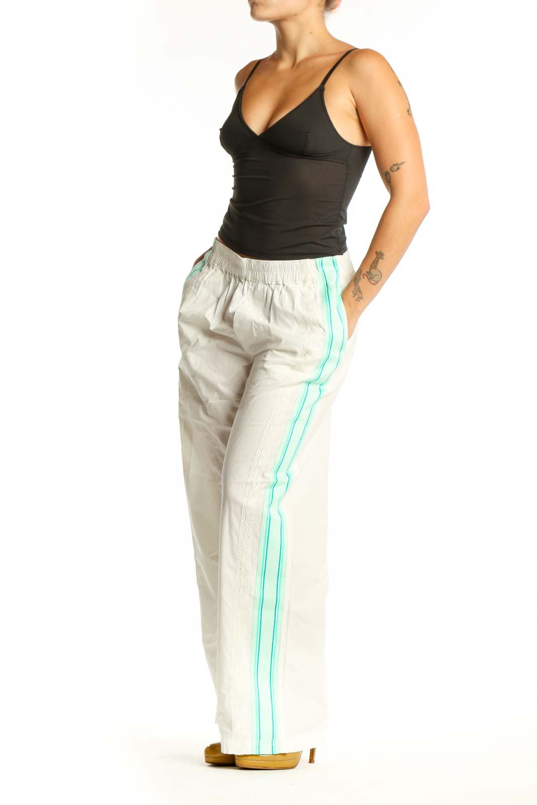 Front view of cream and mint colorblock track pants with side stripe detail and elastic waistband