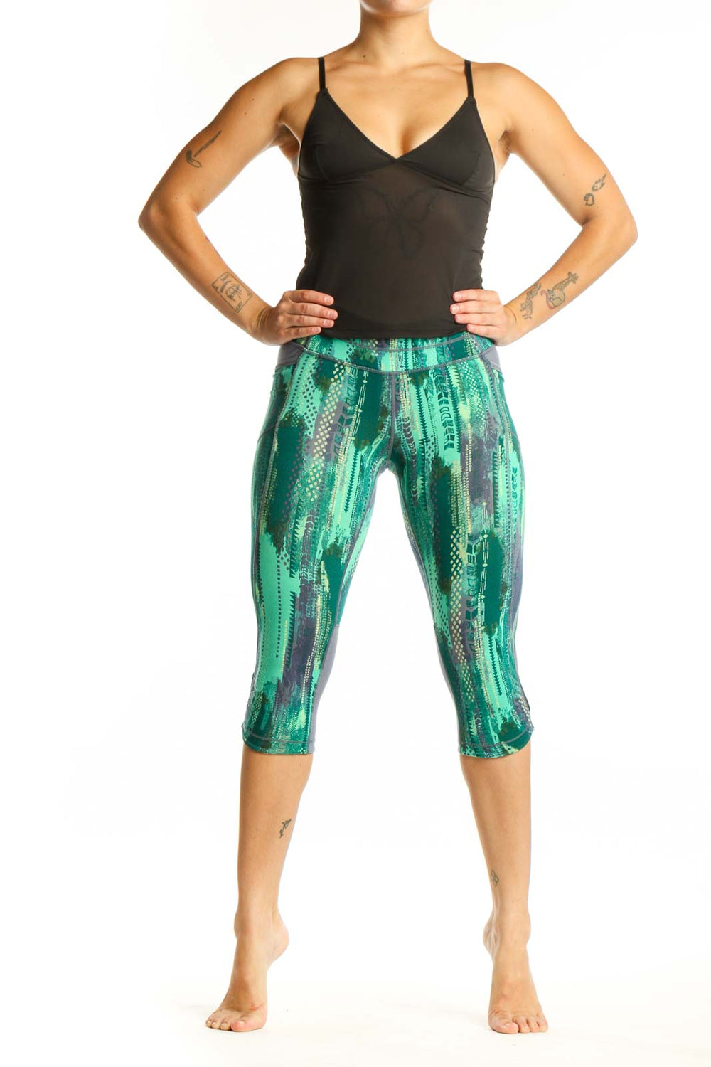 Front view of green geometric print Athleta capri leggings with high-waisted design and four-way stretch fabric