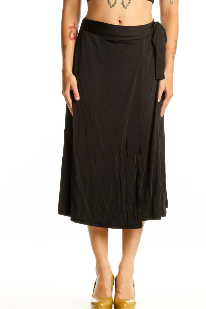 Black wrap midi skirt with tie detail and A-line silhouette by MB by Malene Birger, front view