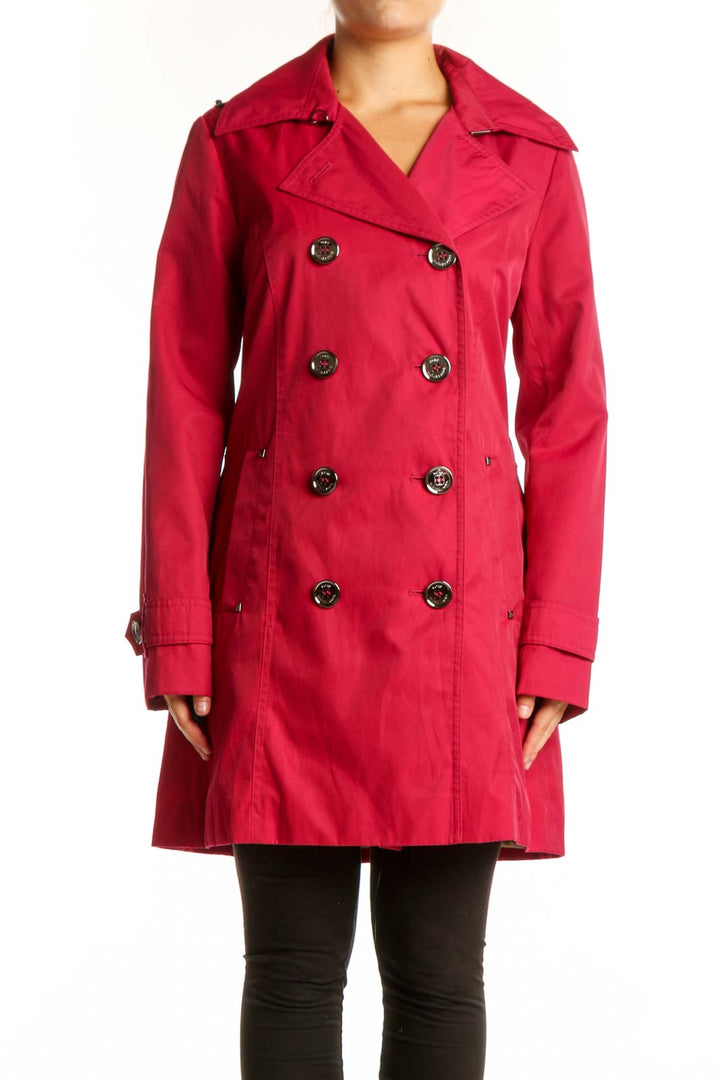 Red double-breasted trench coat by Michael Kors with decorative buttons and notch lapels, front view on model