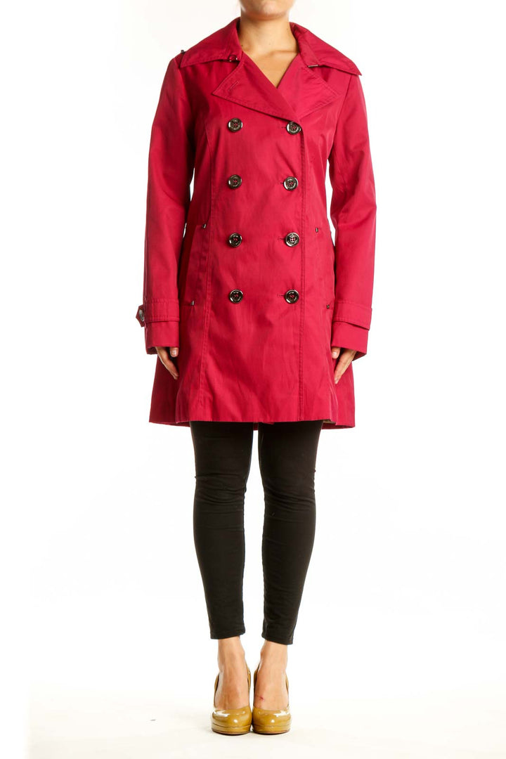 Red double-breasted trench coat by Michael Kors with decorative buttons and notch lapels, front view on model