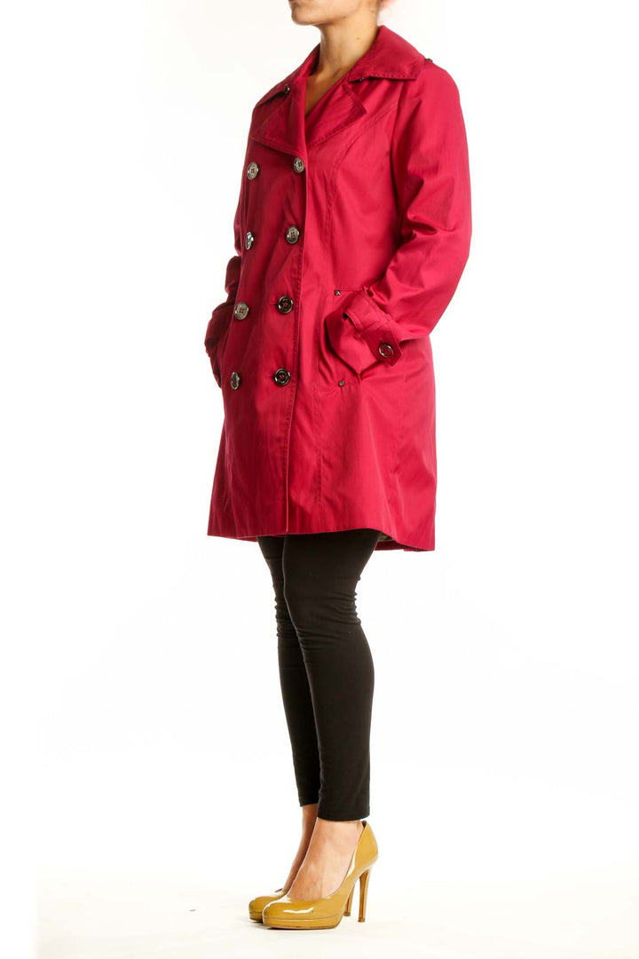 Red double-breasted trench coat by Michael Kors with decorative buttons and notch lapels, front view on model