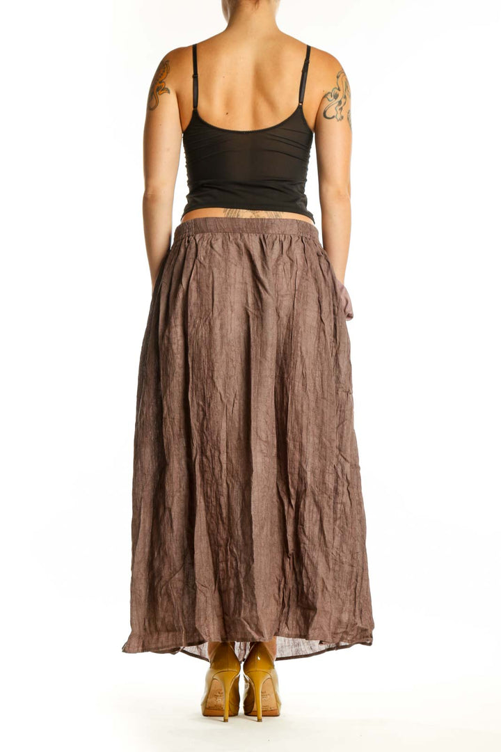 LINTICO brown maxi skirt back view showing flowing fabric and relaxed fit