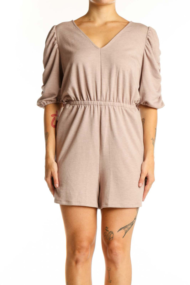 Beige puff sleeve romper with V-neckline and cinched waist, front view