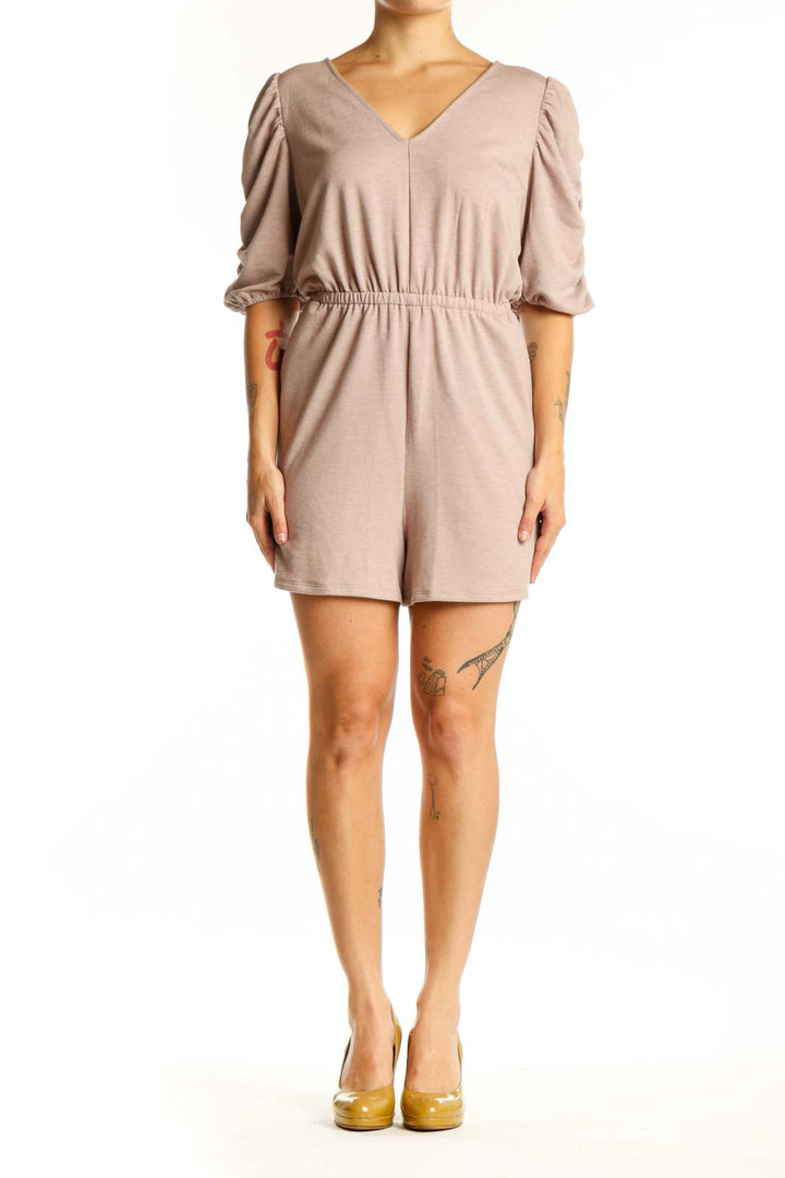 Beige puff sleeve romper with V-neckline and cinched waist, front view